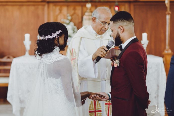 The priest addressing Javon and Kinisha at the altar