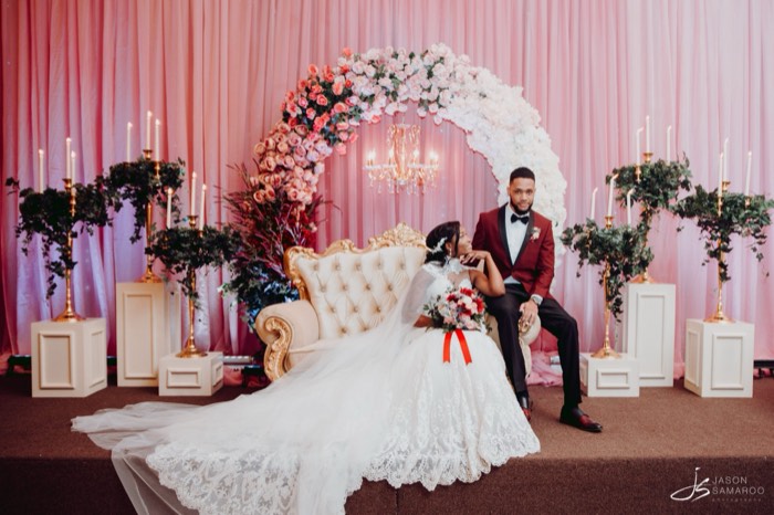 Kinisha and Javon by the floral arch at Signature Hall